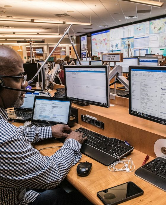 man in black and white checkered dress shirt using computer